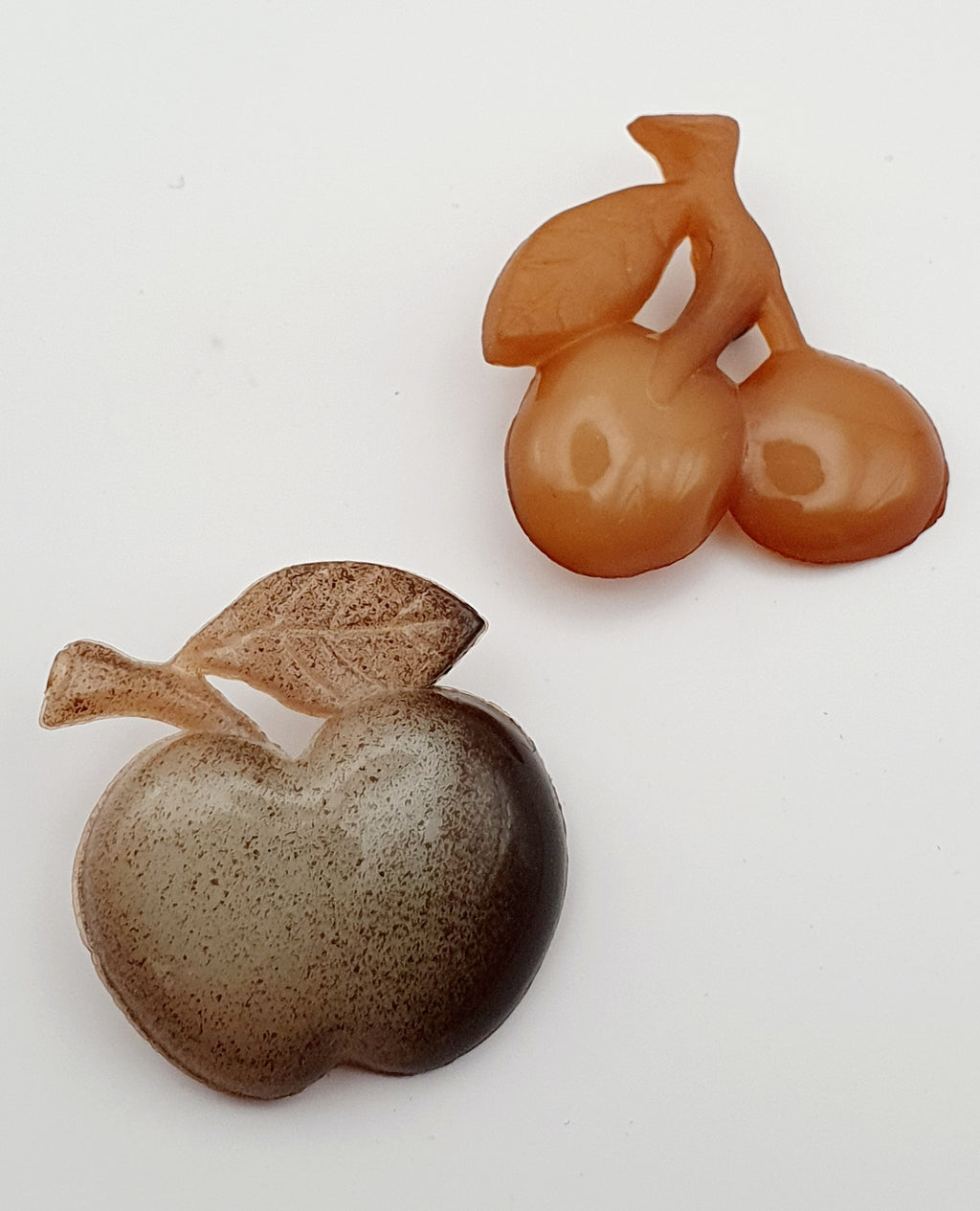 Napite Oy, two brooches, apple and cherries
