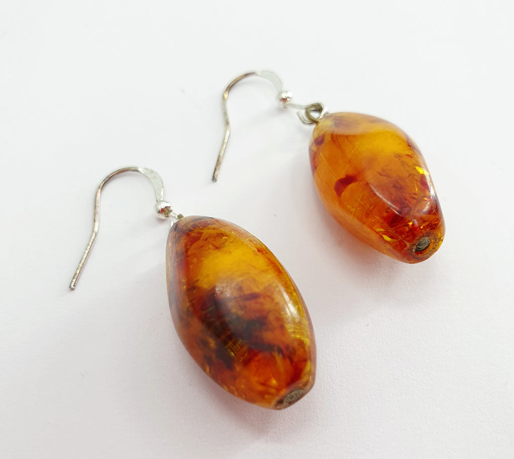 Earrings, amber colored pendant